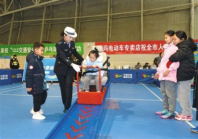 图为小朋友现场体验车辆安全带保护装置。戎禹仁摄 图为小朋友现场体验车辆安全带保护装置。戎禹仁摄