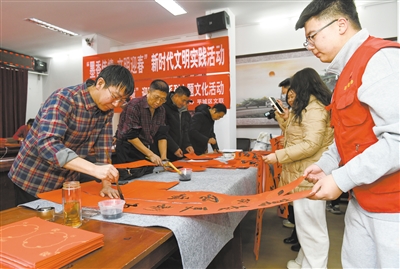 图为我市书法家们在福寓苑社区为居民书写春联。于宏 摄