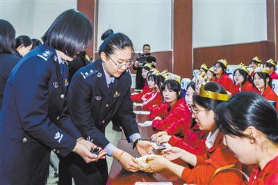 图为活动中，民警为学生送上法治礼物。韩堃摄