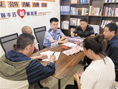 图为庄奇峰等人悉心调解，帮助受伤农民工维权。资料图片